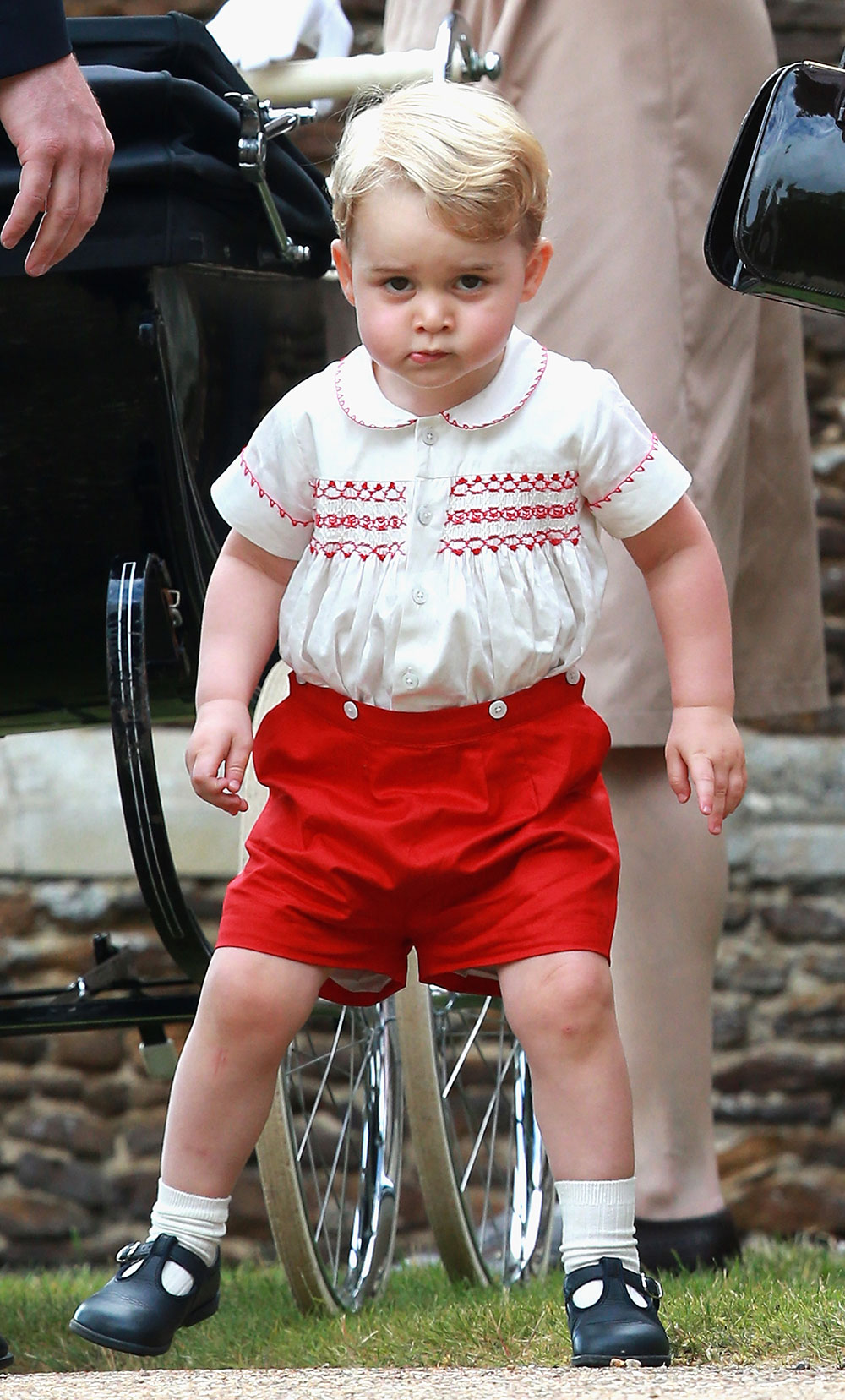 Prince George payed an homage to his father wearing a Rachel Riley white smocked top and bright red shorts, similar to the outfit worn by Prince William when he met his younger brother for the first time in September 1984.