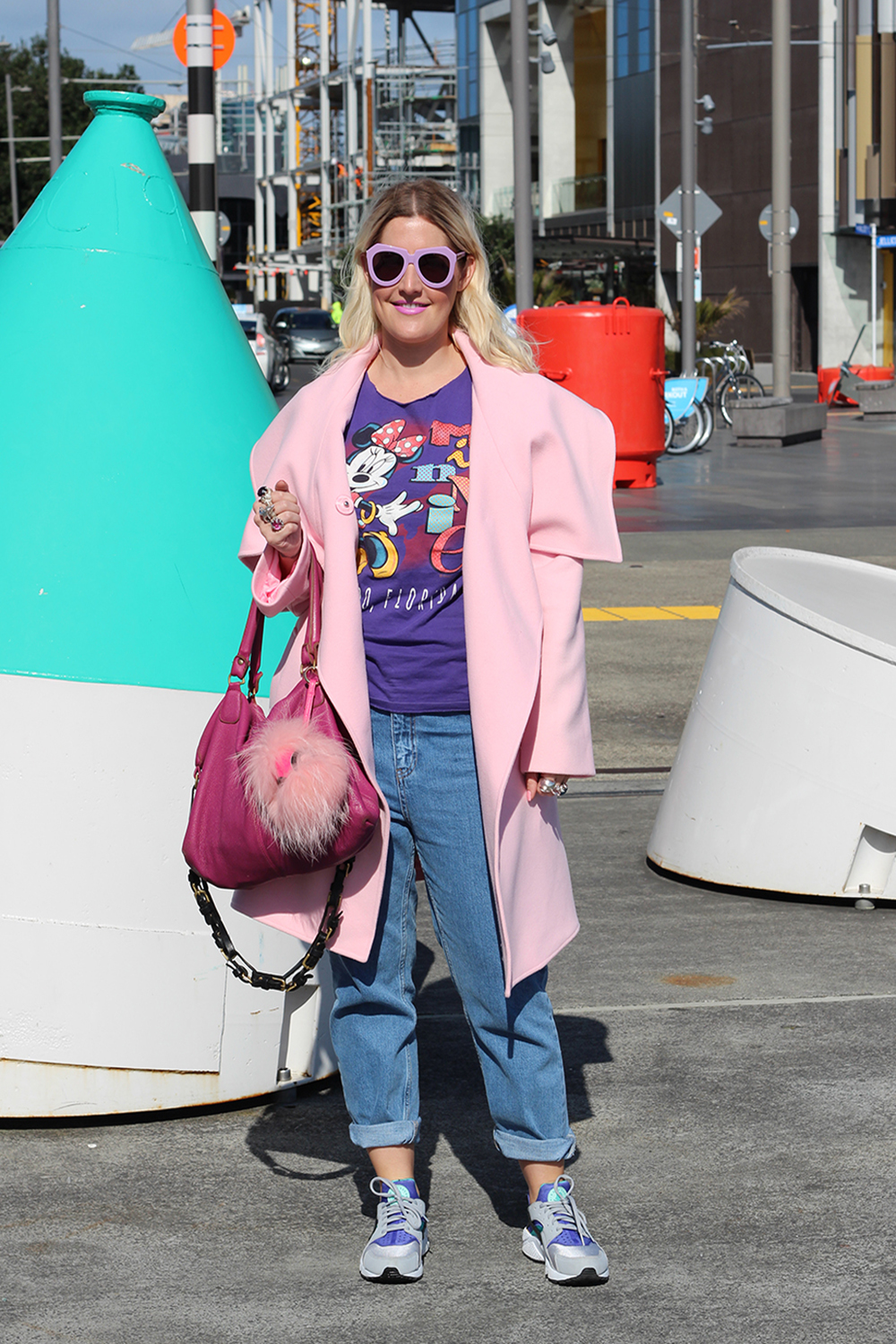 Louise wears vintage top, Harman Grubisa coat, Topshop jeans, Zora Bell Boyd rings, Karen Walker rings, Deadly Ponies bag, Nike shoes and Karen Walker sunglasses.