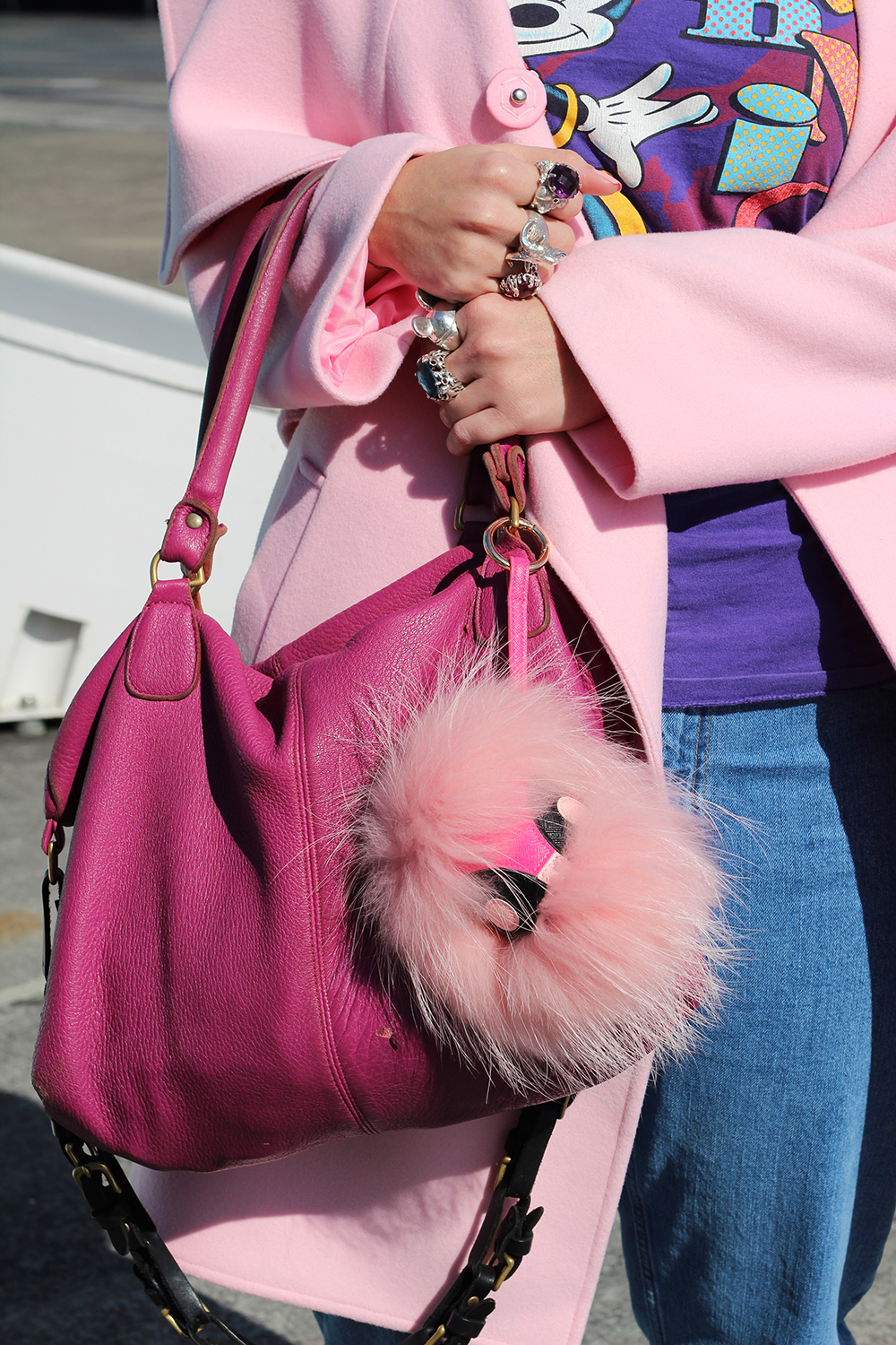 Louise wears vintage top, Harman Grubisa coat, Topshop jeans, Zora Bell Boyd rings, Karen Walker rings, Deadly Ponies bag, Nike shoes and Karen Walker sunglasses.