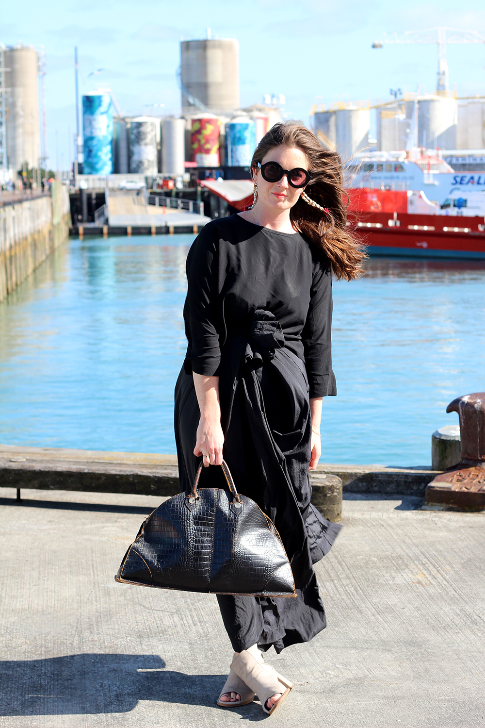 Jasmin wears her own earrings, her own top, Karen Walker trench as skirt, vintage bag, Wildfox sunglasses and ASOS shoes.