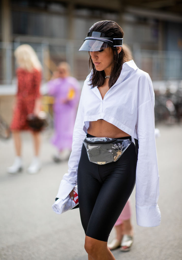 COPENHAGEN, DENMARK - AUGUST 08: A guest wearing cycle pants, belt bag, cropped top, boots is seen outside J.Lindeberg during the Copenhagen Fashion Week Spring/Summer 2019 on August 8, 2018 in Copenhagen, Denmark. (Photo by Christian Vierig/Getty Images)