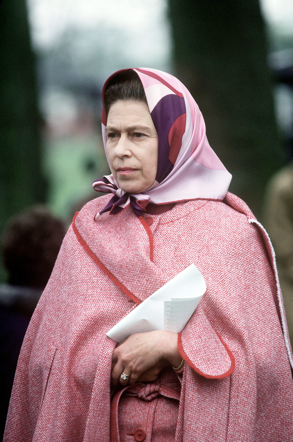 A cape coat and graphic headscarf ensure the Queen is a standout at the Royal Windsor Horse Show in 1979. Photo / Getty Images