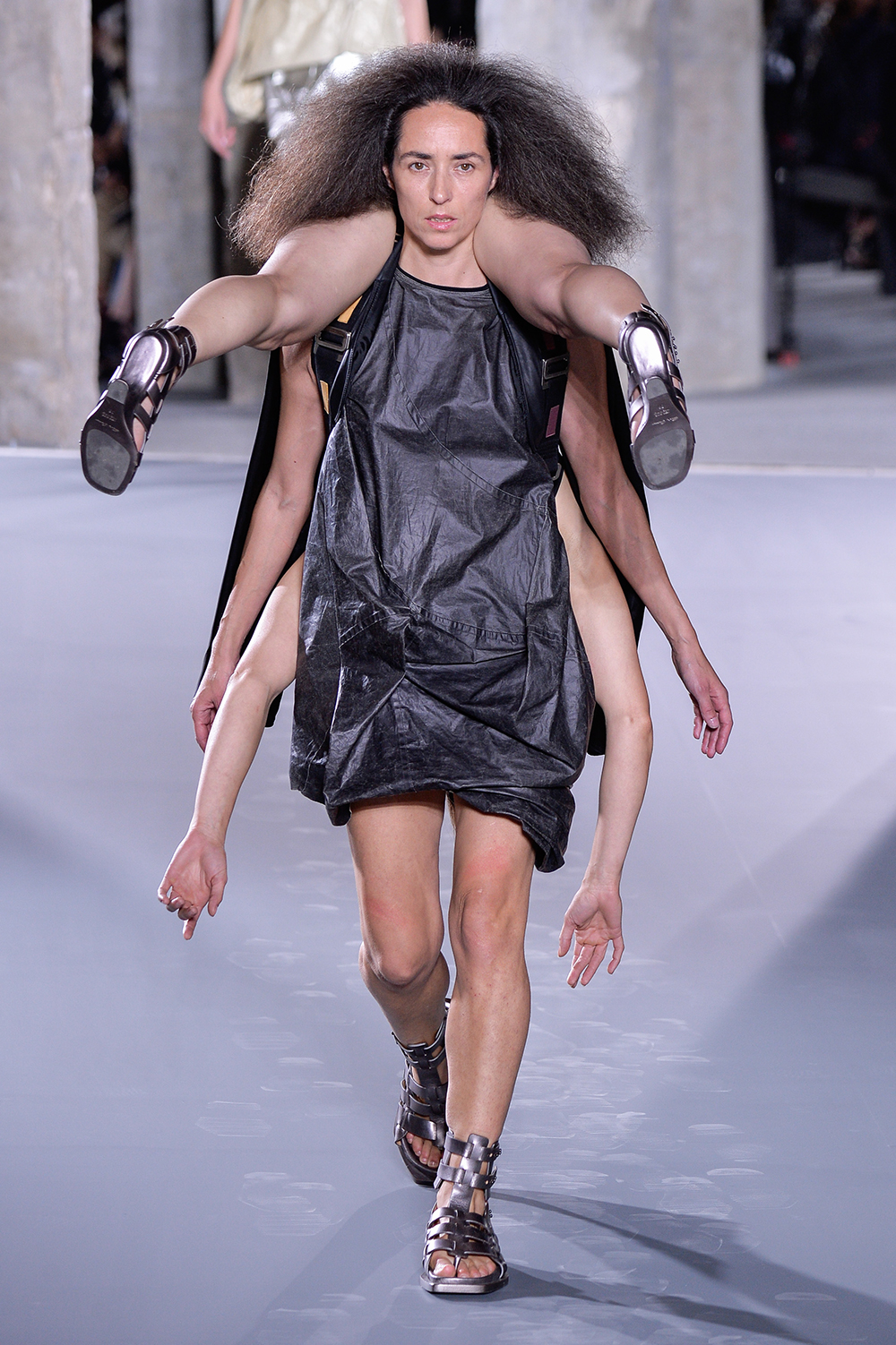 Models accessorised with other models at Rick Owens. The designer's show notes read: 