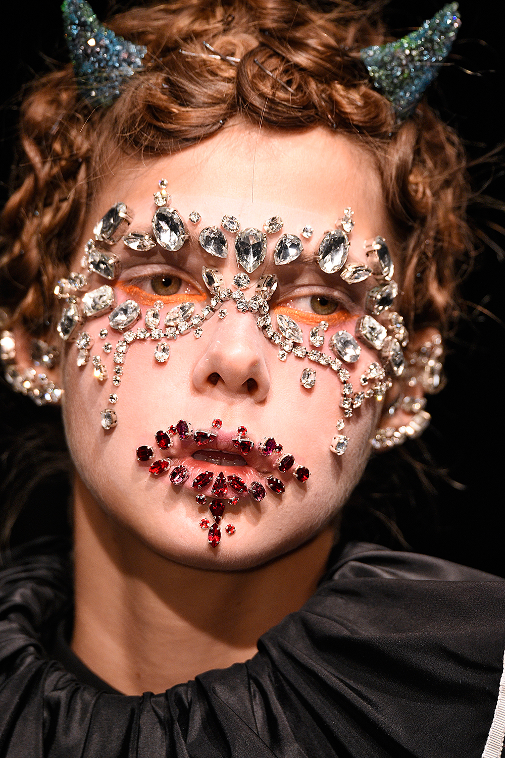 Uncovered's designer Jun Takahashi adorned models with face jewels and glittered devils horns.