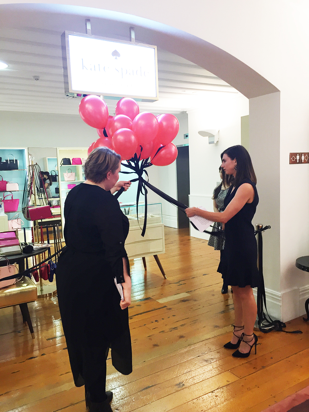 Fashion Quarterly editor Sally-Ann Mullin and T Galleria by DFS General Manager Carly Robertson cut the ribbon to officially open the Kate Spade boutique
