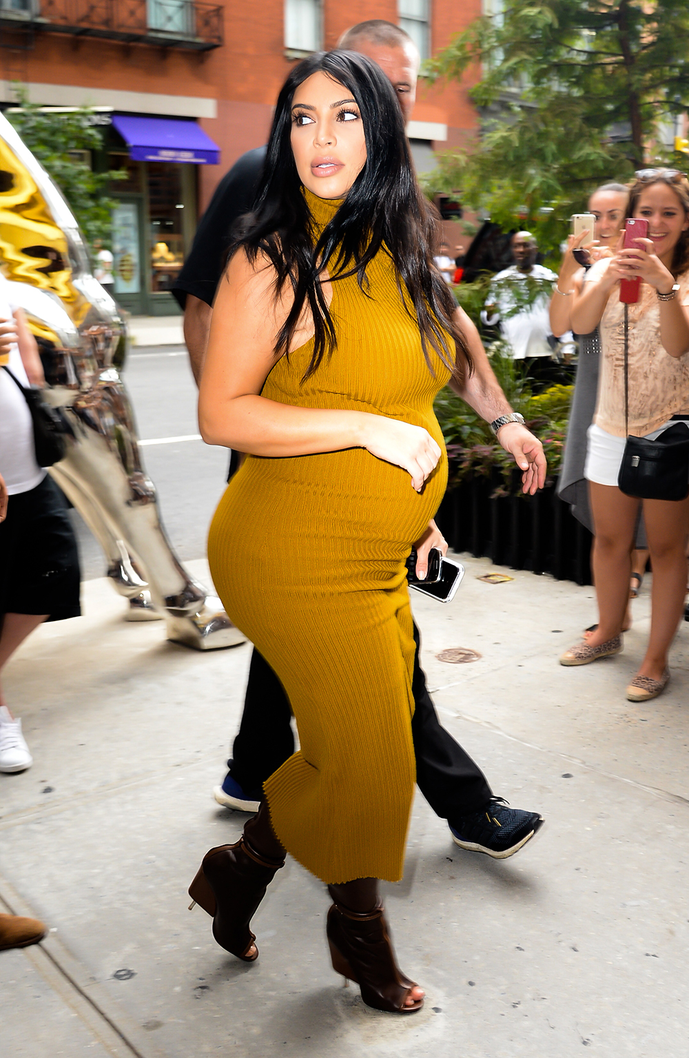 SEPTEMBER 9, 2015: In a colour we don't see her wearing very often, Kim opts for a high-necked jersey dress in mustard while out and about in New York. Photo / Getty Images