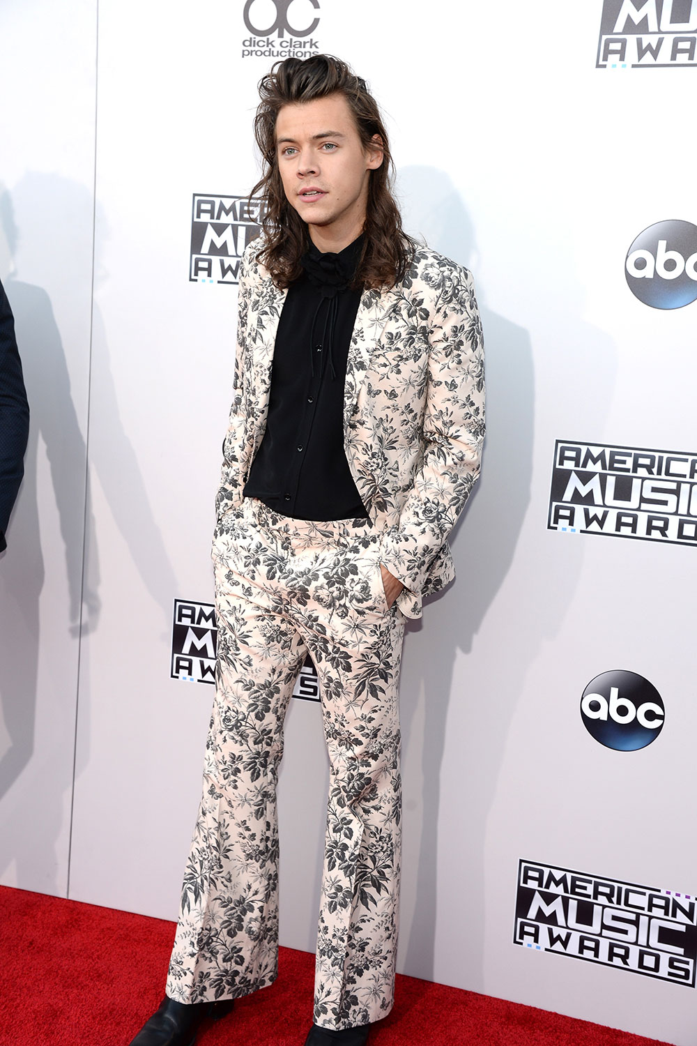 Harry Styles takes things in a different direction with a floral print Gucci suit.