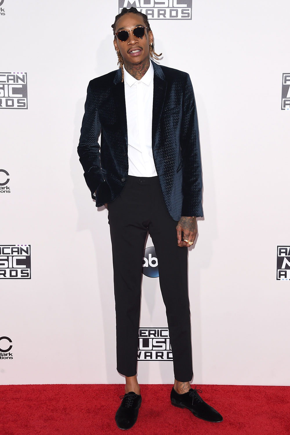 Wiz Khalifa kills it in a navy blue smoking jacket and cropped trousers.
