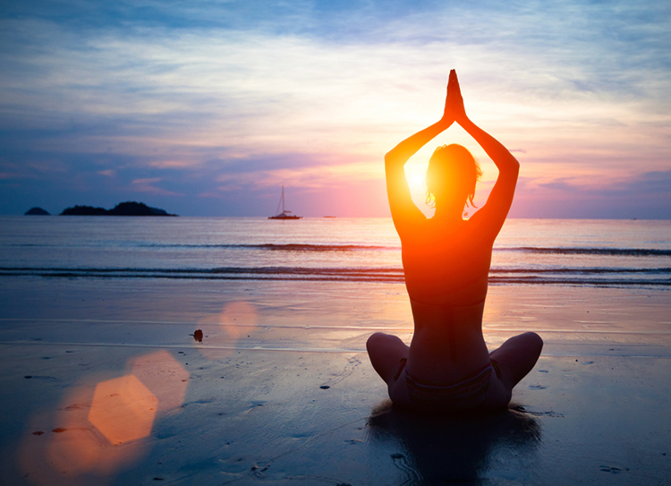 Thailand_Silhouette-young-woman-practicing-yoga-on-the-beach-at-sunset