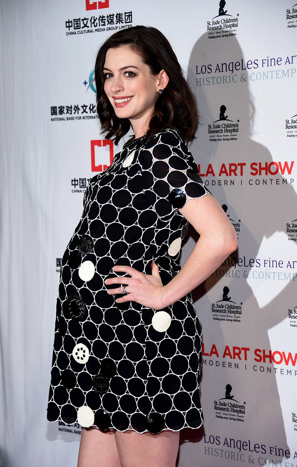 A pregnant Anne Hathaway arrives at the LA Art Show and Los Angeles Fine Art Show's 2016 Opening Night Premiere Party .