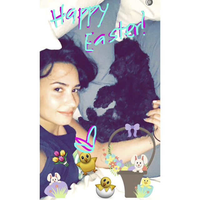 Demi Lovato cuddled up with her dog to wish her fans a Happy Easter.