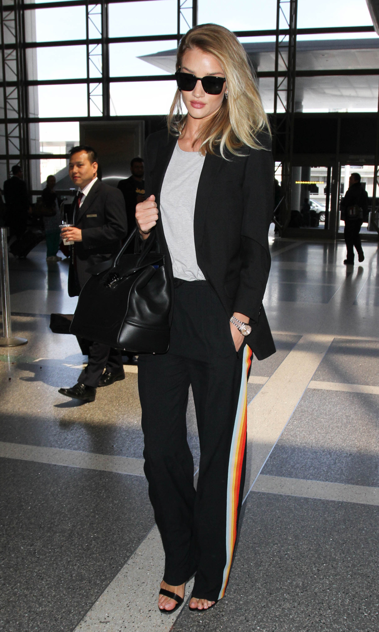 British supermodel Rosie Huntington-Whiteley keeps things classic in a black blazer and on-trend striped trackpants as she departs LAX.