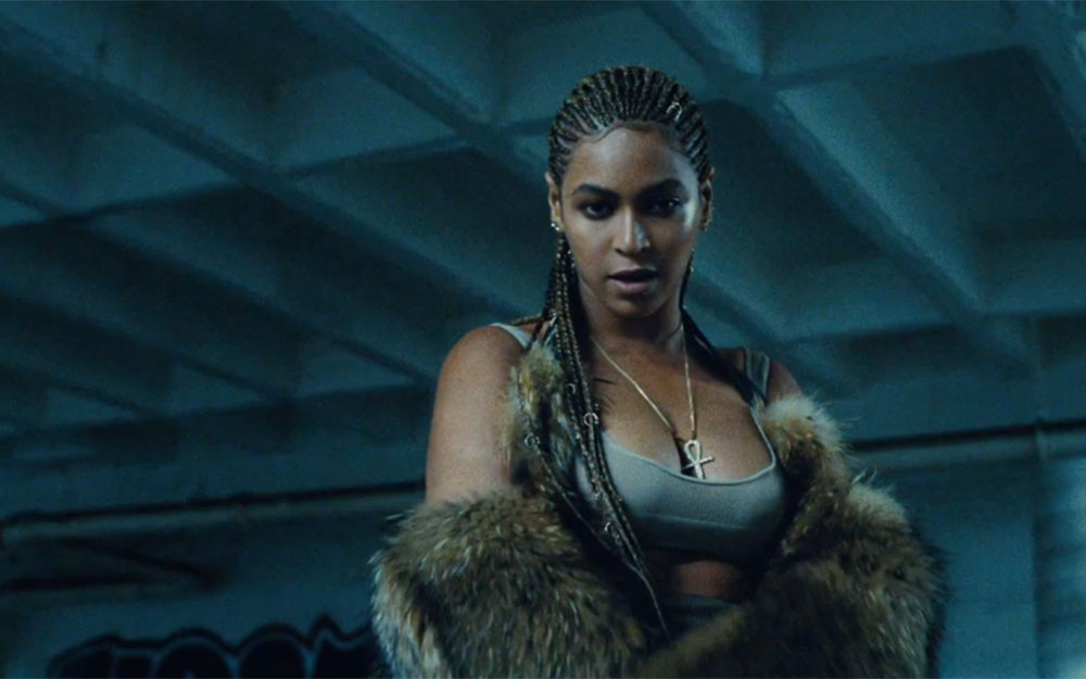 Beyonce wears Hood by Air fur coat and Yeezy crop top and necklace by Lynn Ban