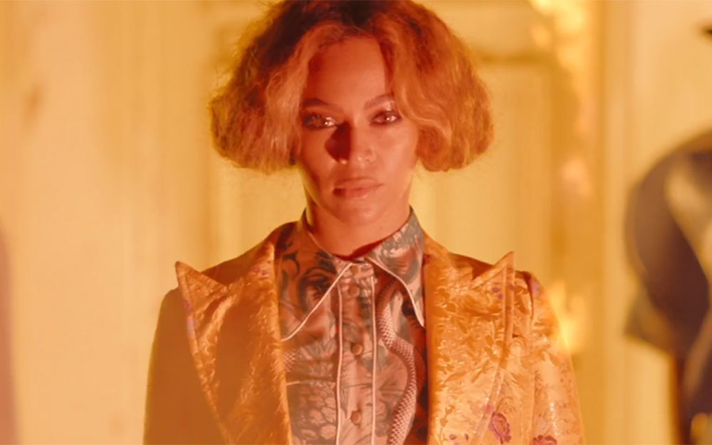 Beyonce wears a Gucci shirt and suit jacket