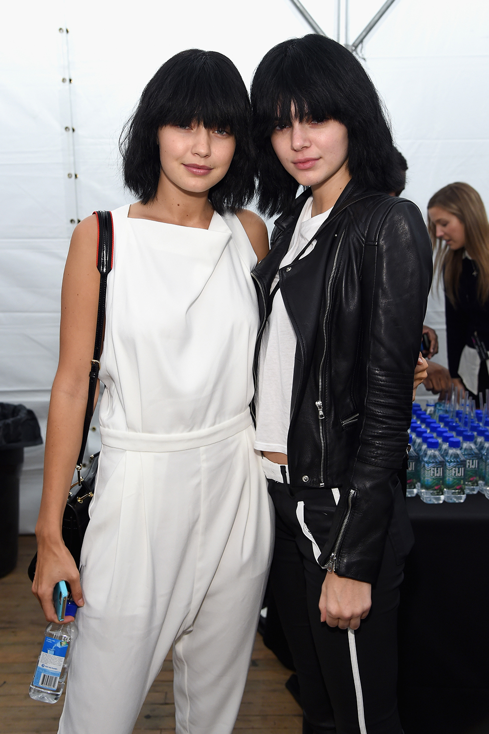 Backstage at Marc Jacobs the girls look unrecognizable in matching black wigs in September 2014.