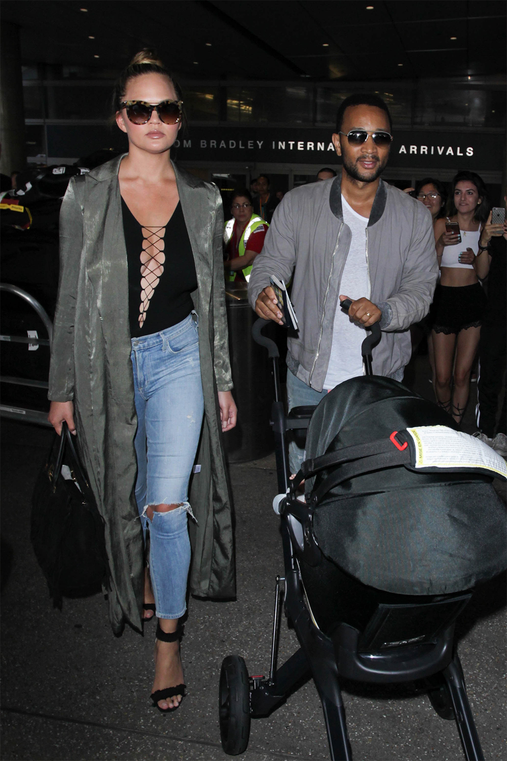 Chrissy Teigen and John Legend are seen at LAX.