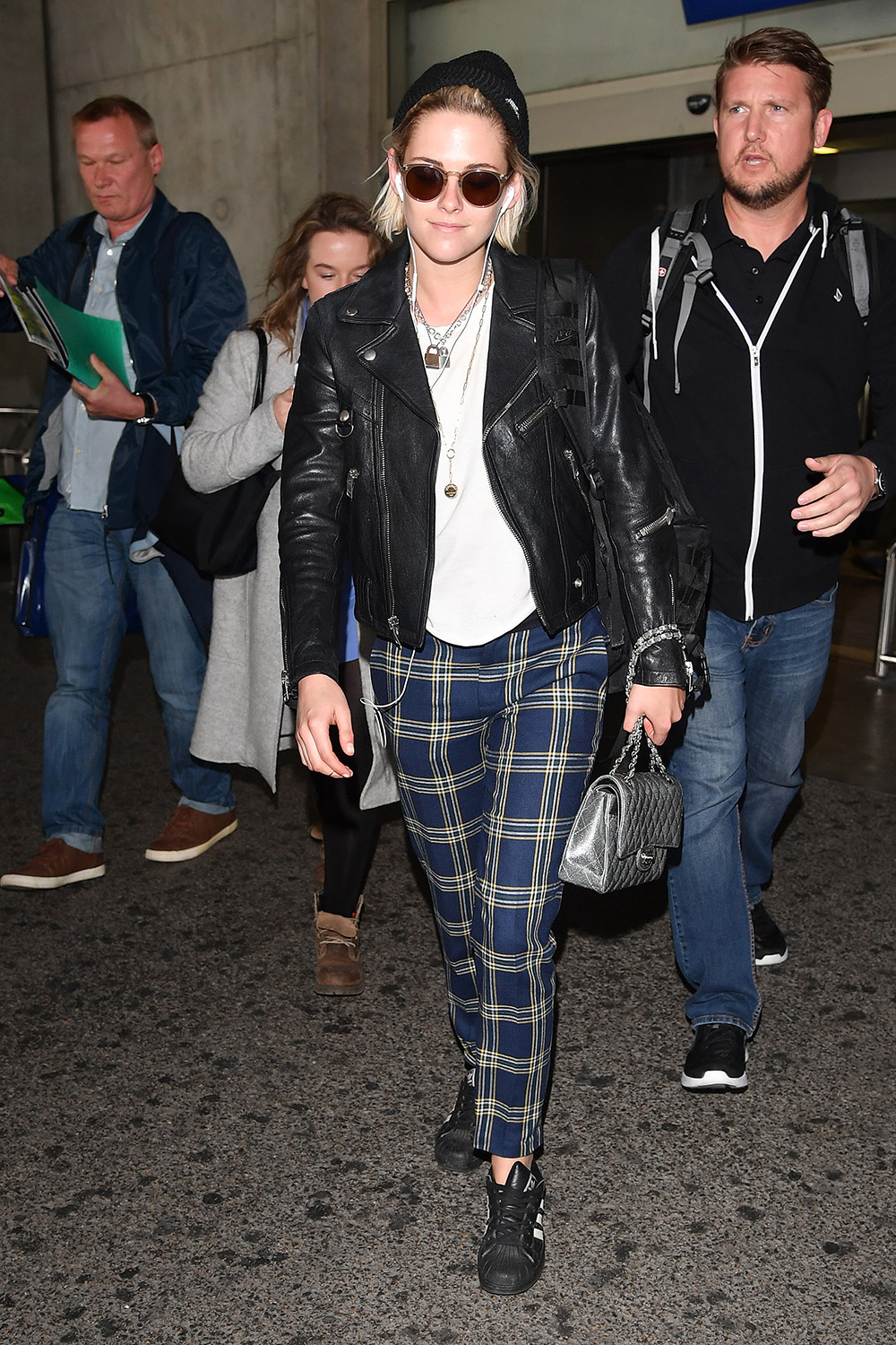 Kristen Stewart looks ready to rock and roll in a pair of plaid pants and leather jacket as she touches down in France to promote her new film Cafe Society in Cannes.