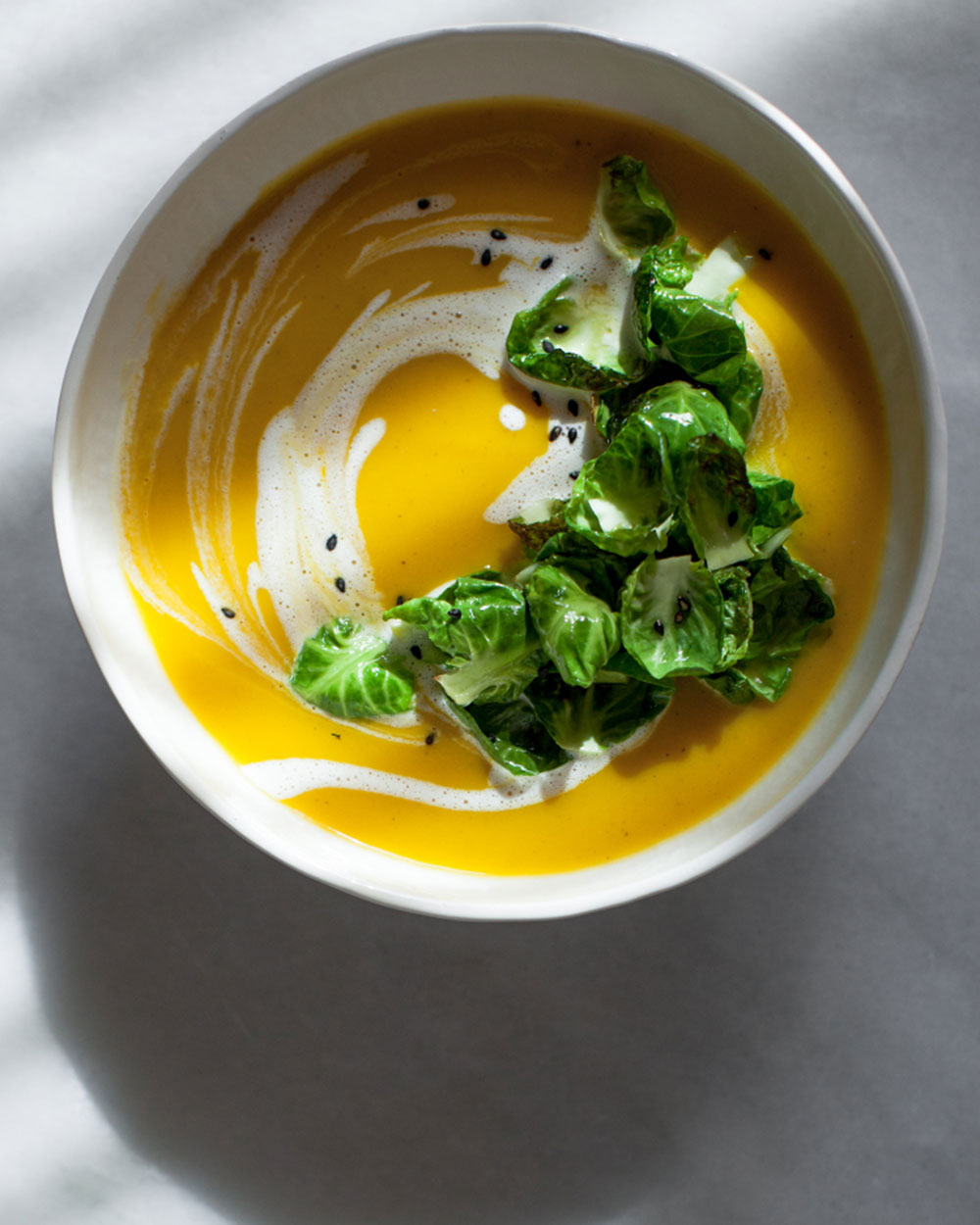 Spiced butternut-leek soup with brussels sprout leaves, browned butter, and orange crème fraîche from Lemon Fire Brigade