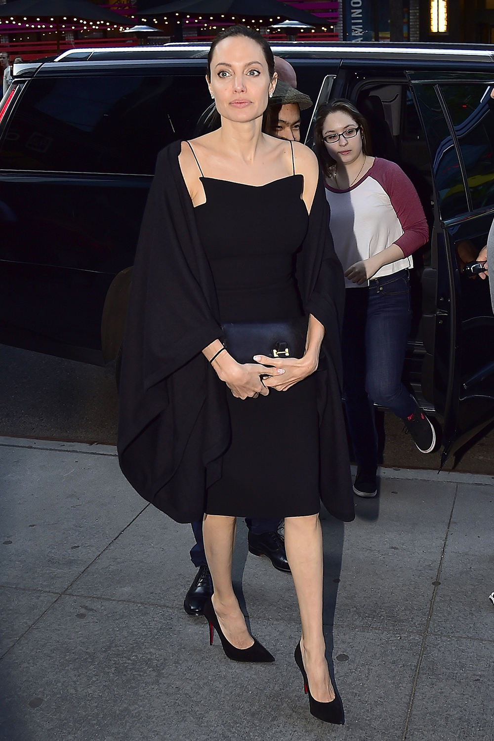Angelina Jolie looks elegant in a structured little black dress out with her children in New York.