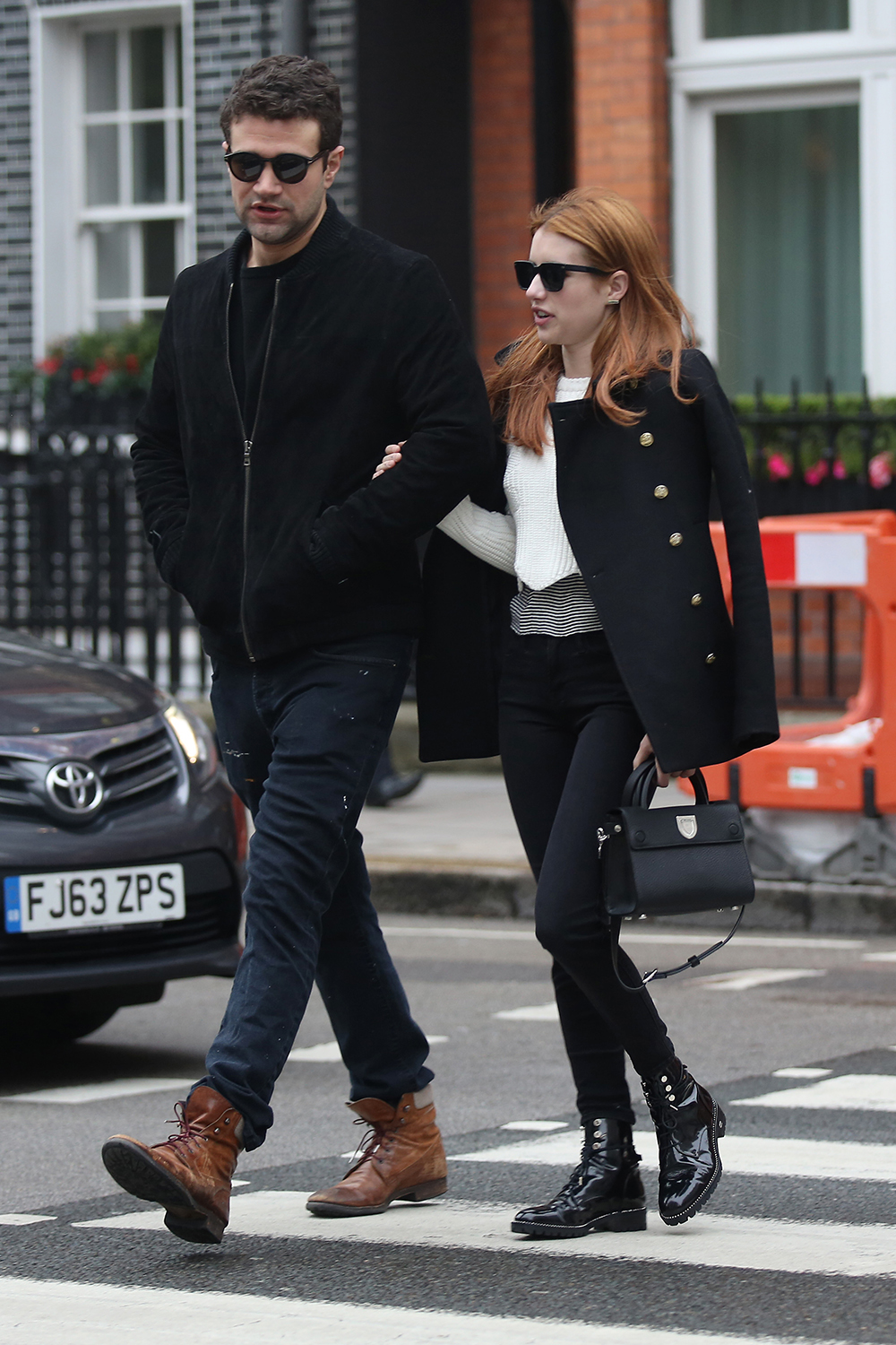 Emma Roberts keeps things chic in black and white while out and about with a friend in Mayfair, London.