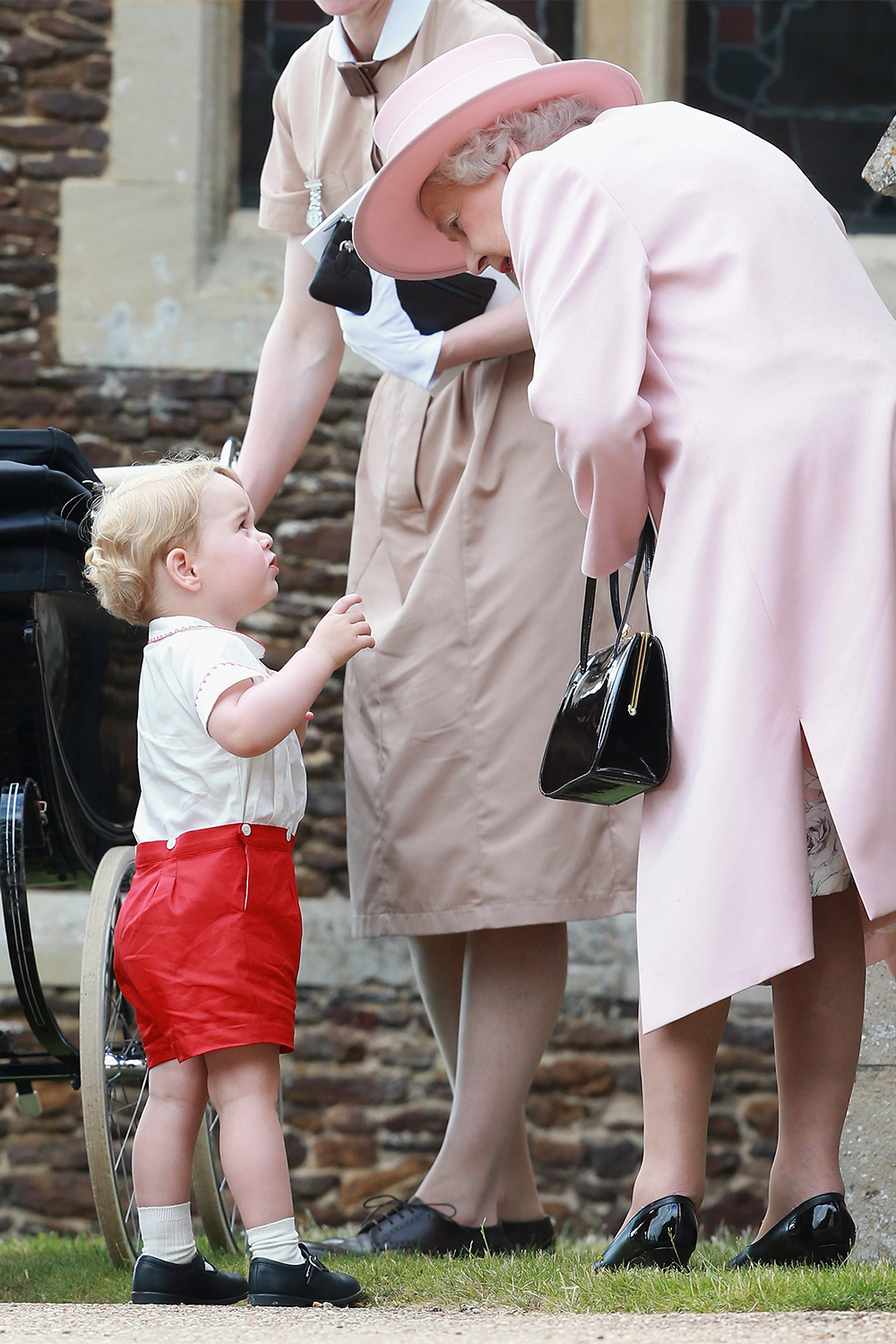 Chatting to Gam-Gam at his little sister Princess Charlotte's Christening at the Church of St Mary Magdalene on the Sandringham Estate on July 5, 2015.