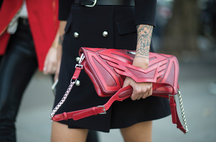 A guest is wearing a red bag seen after the Balmain show during Paris Fashion Week SpringSummer 2017 on September 29, 2016