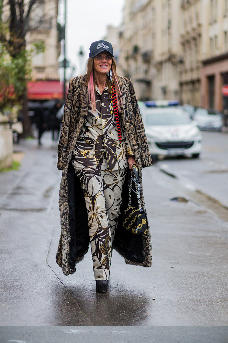 Anna dello Russo is wearing a Nike Air cap a Roberto Cavalli leopard coat and For Restless Sleepers pyjama suit and a Louis Vuitton bag outside Moncler Gamme Rouge during the Paris Fashion Week Womenswear Fall/Winter 2016/2017 on March 9, 2016