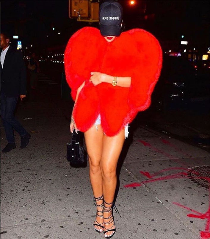 Snapchatting up a storm on the streets of NYC Rihanna wore this heart-stopping red Saint Laurent coat.