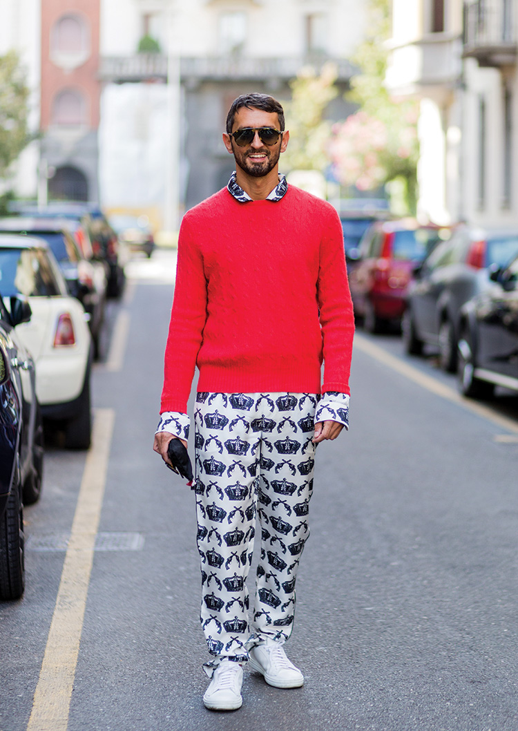 Simone Marchetti wearing a silk overall and red sweater outside Dolce & Gabbana during Milan Fashion Week SpringSummer 2017 on September 25, 2016
