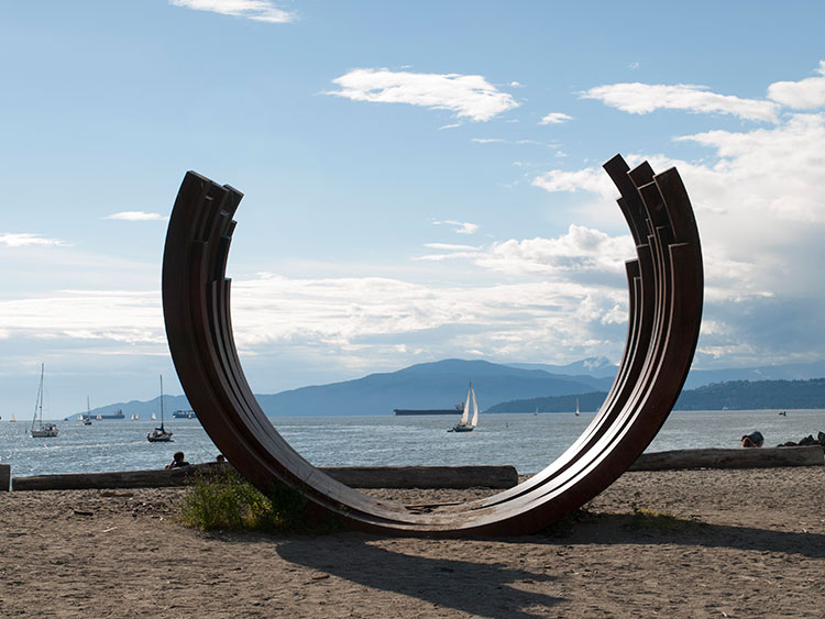 Large metal arches frame the view in English Bay.