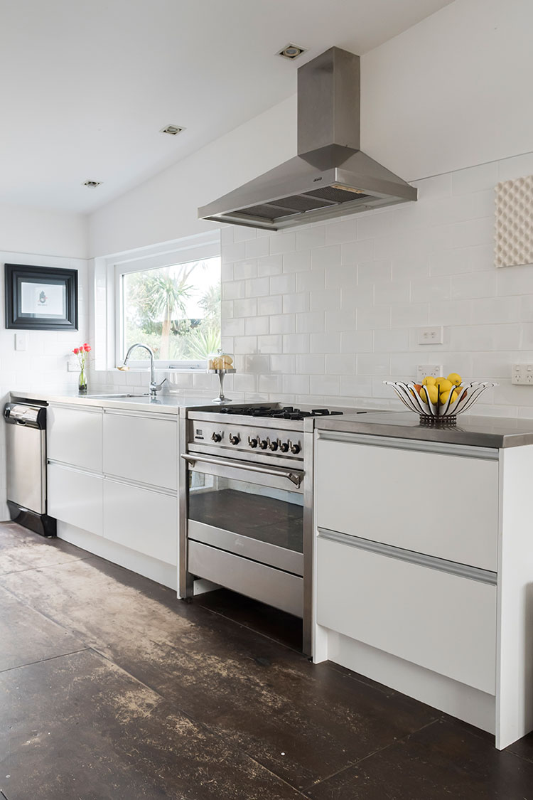 The clean, white kitchen features a Smeg oven and subway tiles from Tile Warehouse.