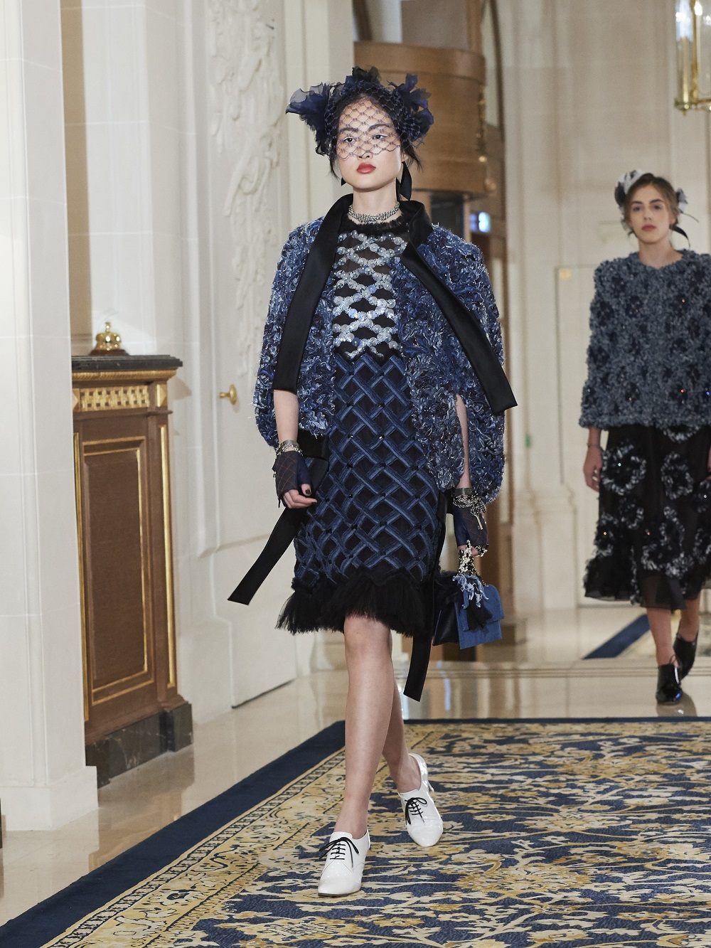 A model wears a two piece skirt suit on the runway at Chanel's pre-fall 2017 collection at The Ritz