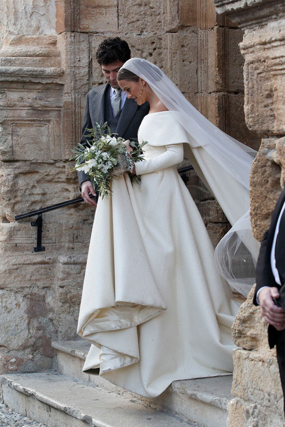 The gorgeous cream off-the-shoulder gown with veil proved an elegant choice, despite the initial tussle in the wind upon arriving at the church.