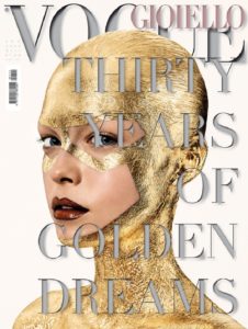 A model with her head and face covered in gold leaf poses for the cover of Vogue jewellery magazine 