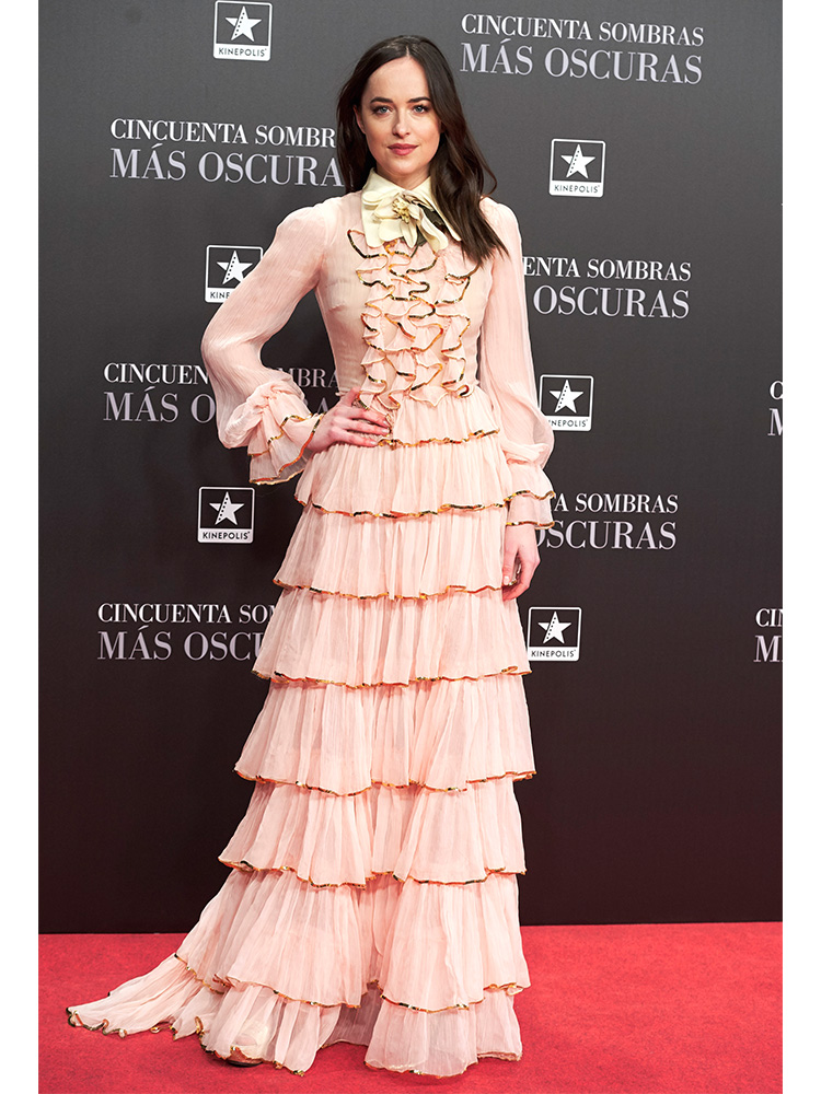 Dakota Johnson may have taken style cues from flamenco dancers with this pale pink Gucci gown in Madrid, Spain, for a 50 Shades Darker premiere.