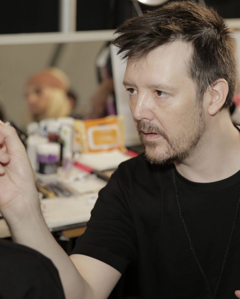 Makeup artist Kabuki works on a face