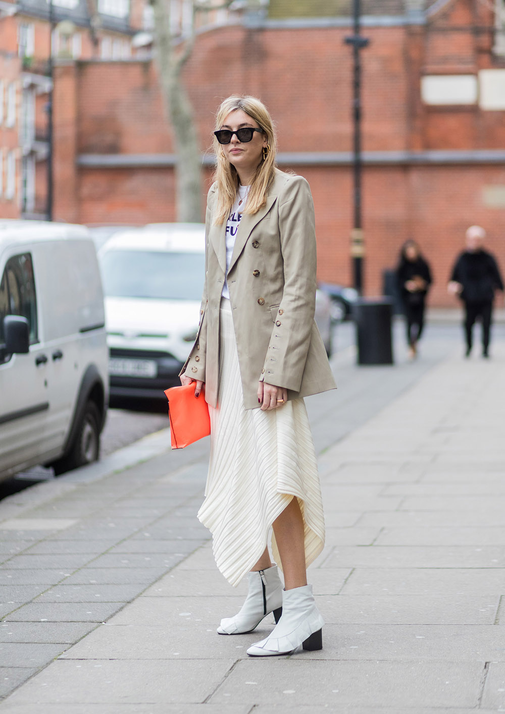 LONDON, ENGLAND - FEBRUARY 19: Camille Charriere wearing a beige jacket, white skirt, Loewe clutch outside Anya Hindmarch on day 3 of the London Fashion Week February 2017 collections on February 19, 2017 in London, England. (Photo by Christian Vierig/Getty Images)