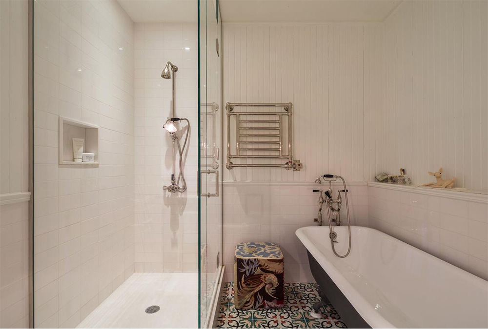 The brand new en-suite/master bath boasts a free-standing vintage clawfoot bath, mosaic tiled floors and wood wall panelling for a classic and timeless appeal.