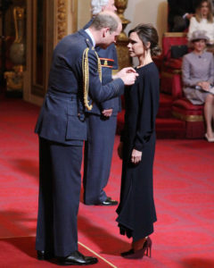 Victoria Beckham is presented her OBE by Prince William