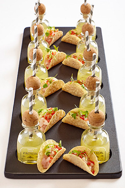 Stylish mini appetizer and drink pairings are becoming increasingly popular. These mini Patron margaritas with taco bites are too cute, and you can't go too far wrong with sliders and mini jugs of beer.
