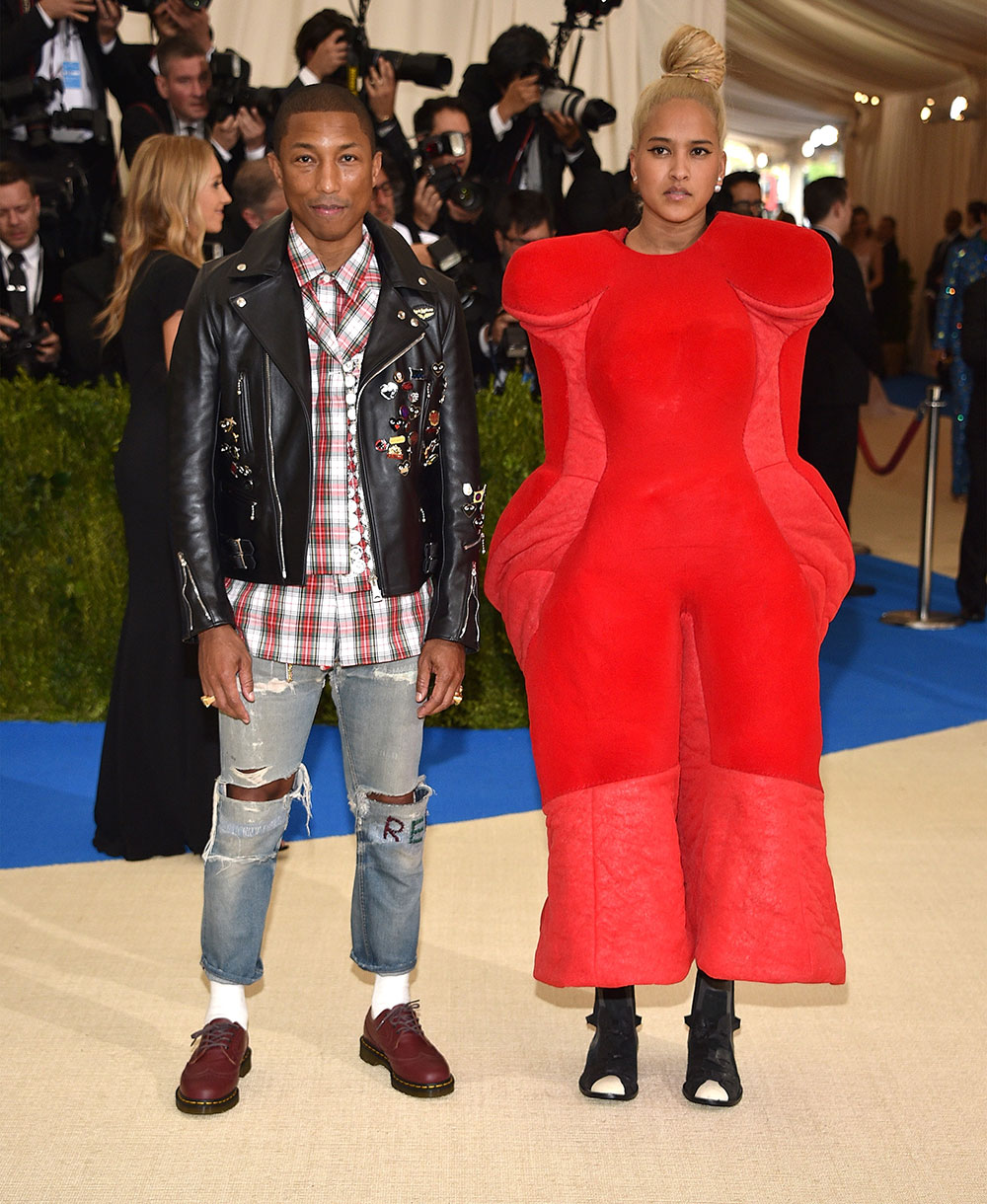 Co-host Pharrell wears Comme des Garçons jeans with a flannel shirt and studded leather jacket. His wife, Helen Lasichanh is wearing Comme des Garçons Fall 2017.