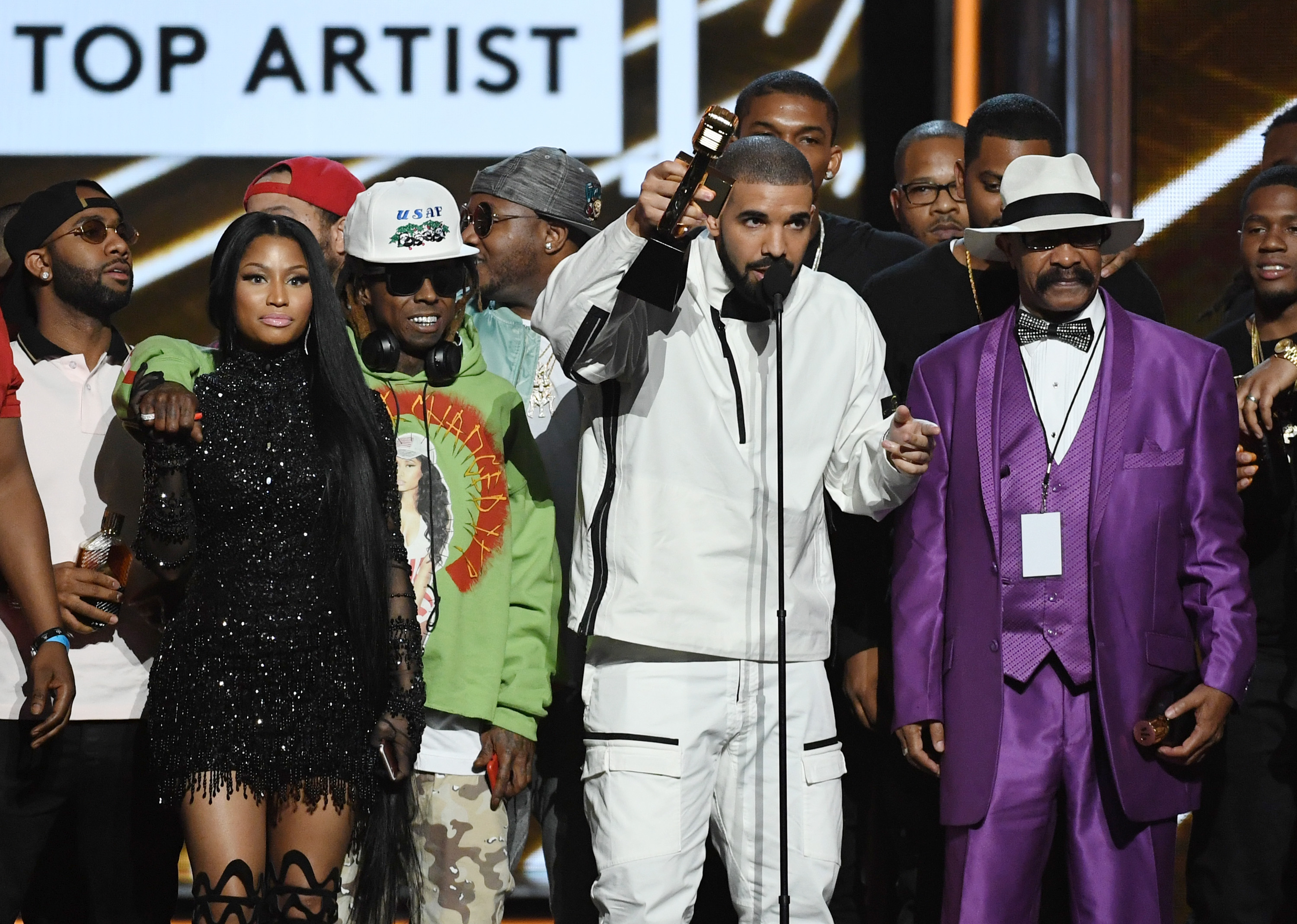 LAS VEGAS, NV - MAY 21: (L-R) Rappers Nicki Minaj and Lil' Wayne look on as recording artist Drake accepts the Top Artist award onstage with his father Dennis Graham during the 2017 Billboard Music Awards at T-Mobile Arena on May 21, 2017 in Las Vegas, Nevada. (Photo by Ethan Miller/Getty Images)