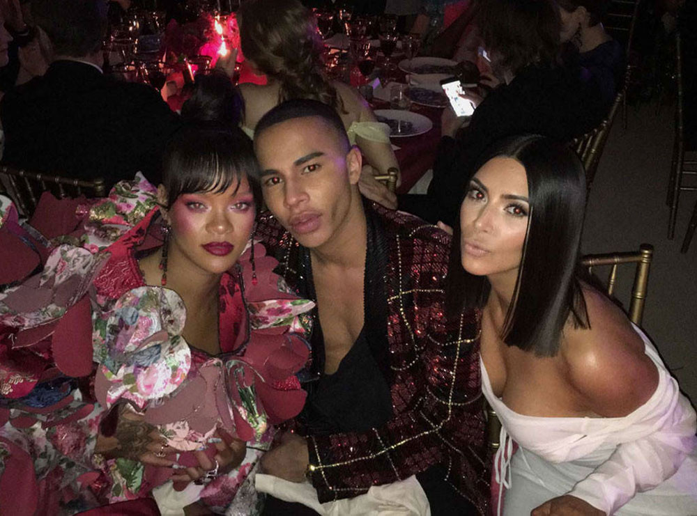 Kim Kardashian West posted a series of pics to her Snapchat, including this one at dinner with Rihanna and Balmain creative director, Olivier Rousteing.