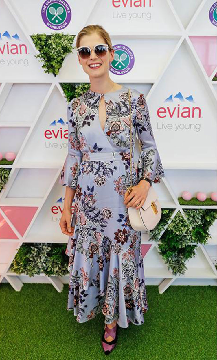 Rosamund Pike wears an Erdem sun dress at a sideline function.