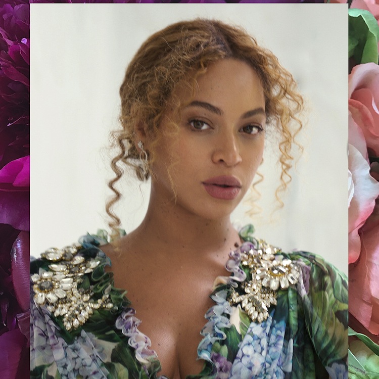 A portrait of singer Beyonce in a floral dress