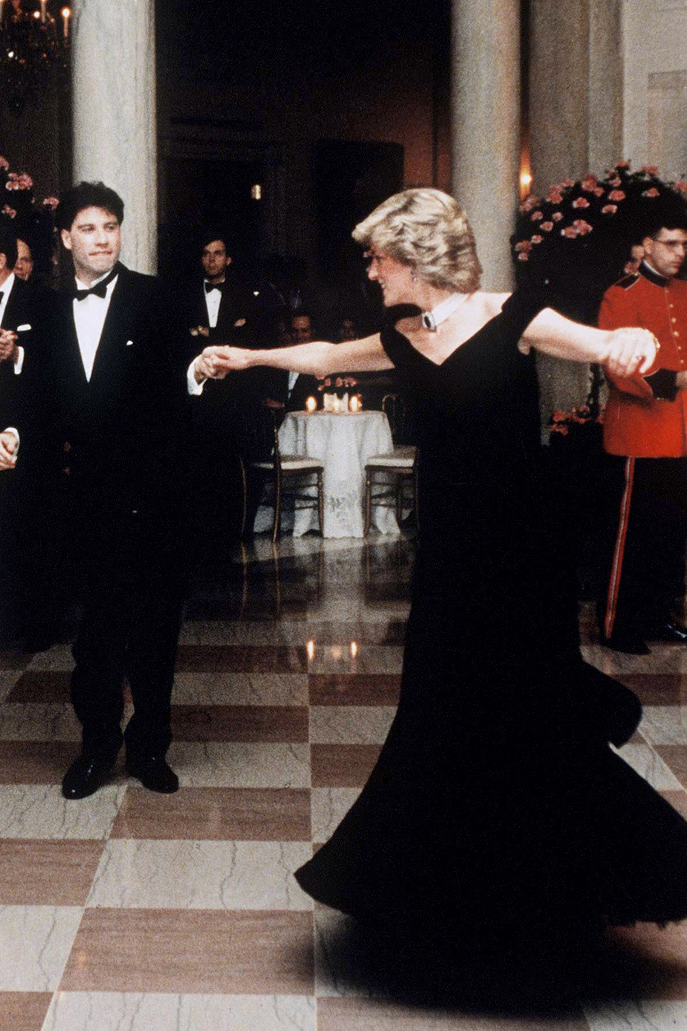 November 9th, 1985 - Princess Diana dances with John Travolta at the White house during their American visit. She wears a gown by Victor Edelstein.