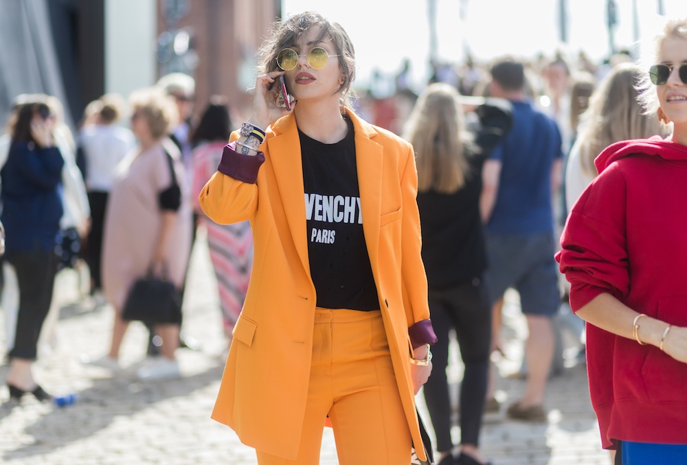 Masha Sedgwick wearing a yellow Lala Berlin suit, Givenchy clutch and tshirt, YSL shoes outside Designers Remix on August 10, 2017 in Copenhagen, Denmark.