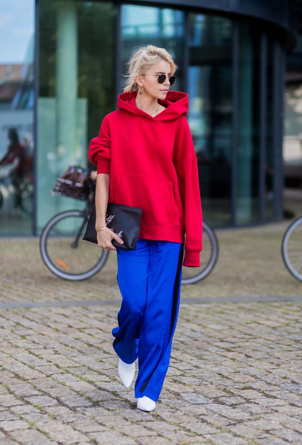 Caroline Daur wearing a red hoody outside Designers Remix on August 10, 2017 in Copenhagen, Denmark.
