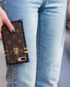 Lisa Hahnbueck wearing light toned cropped Levis Wedgie denim jeans, Louis Vuitton iphone cover on July 17, 2017 in Berlin, Germany
