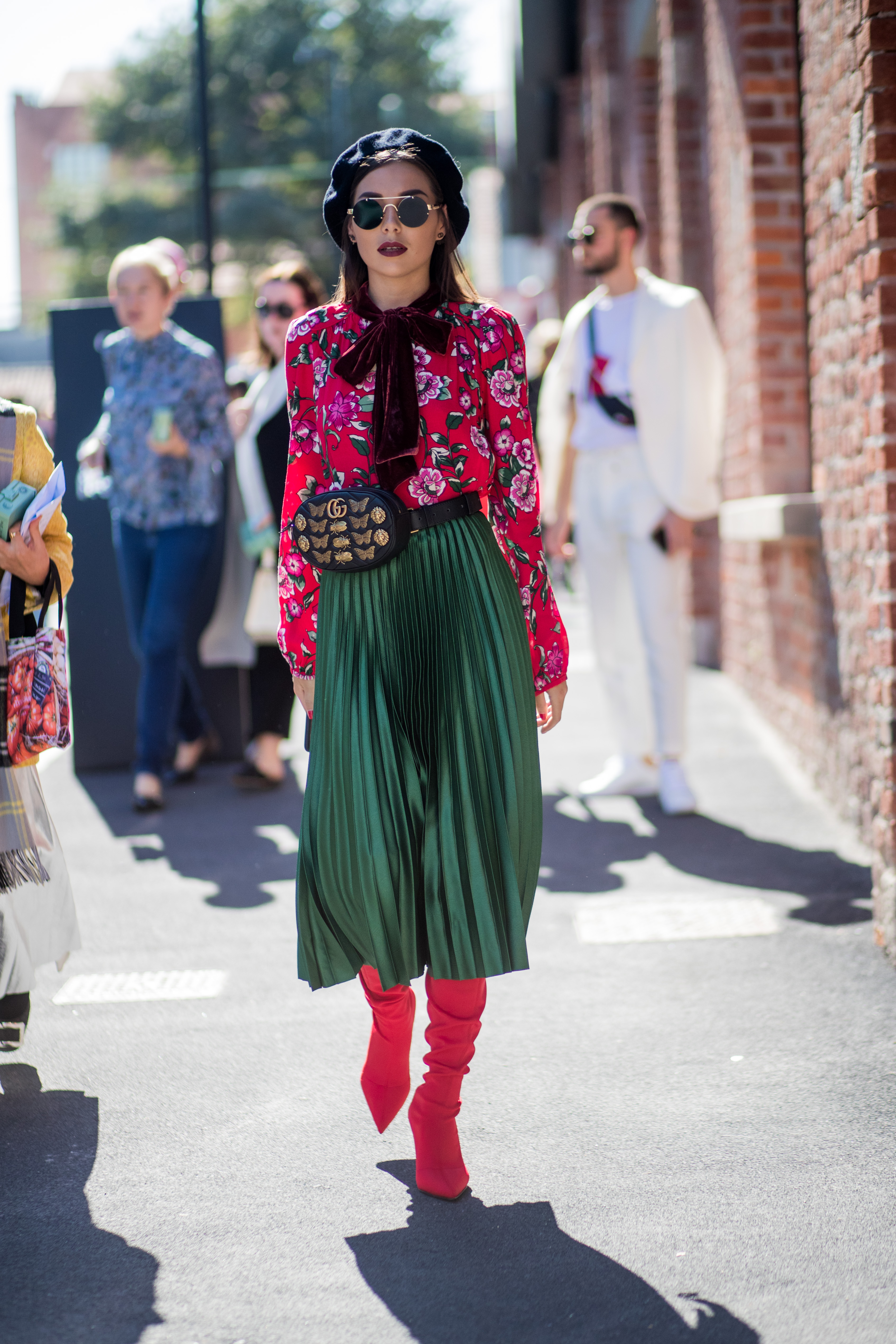 MILAN, ITALY - SEPTEMBER 20: A guest wearing beret, belt bag, red blouse, green maxi skirt, sock boots is seen outside Gucci during Milan Fashion Week Spring/Summer 2018 on September 20, 2017 in Milan, Italy. (Photo by Christian Vierig/Getty Images)